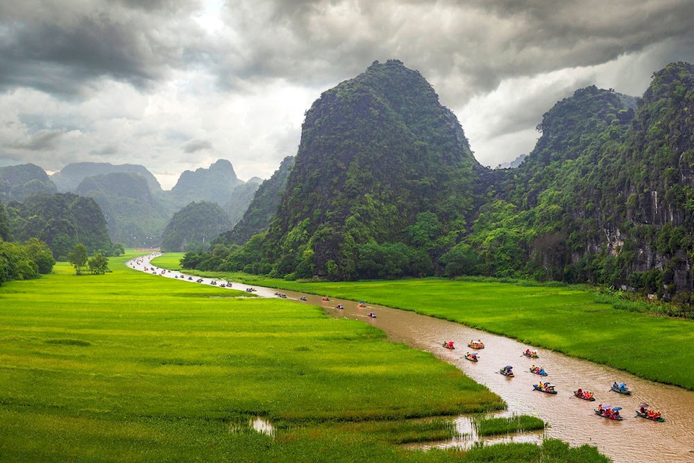 Boating through lush rice fields and dramatic limestone caves is the most exciting experience in Tam Coc - Bich Dong